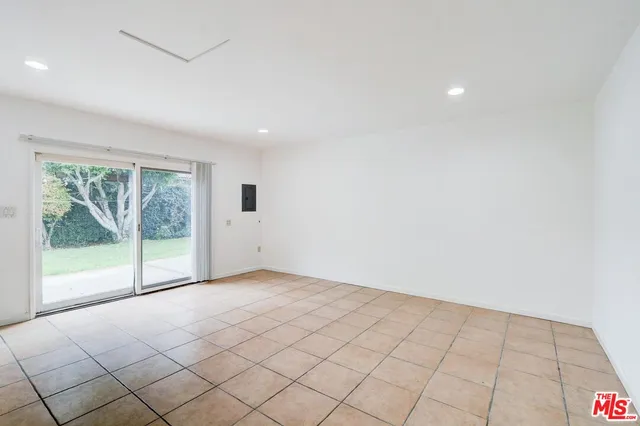 a view of an empty room with glass door