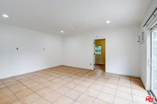 a front view of a house with a garden and yard