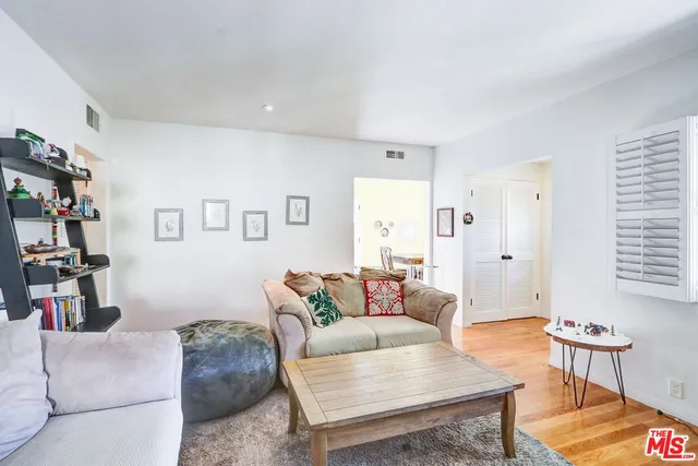a living room with furniture and flowers