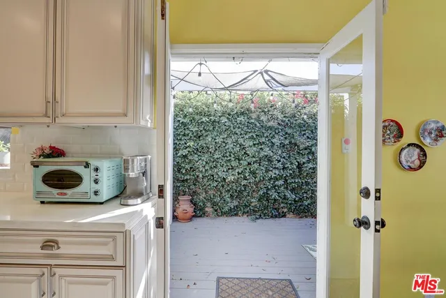 a view of a porch with furniture and wooden floor