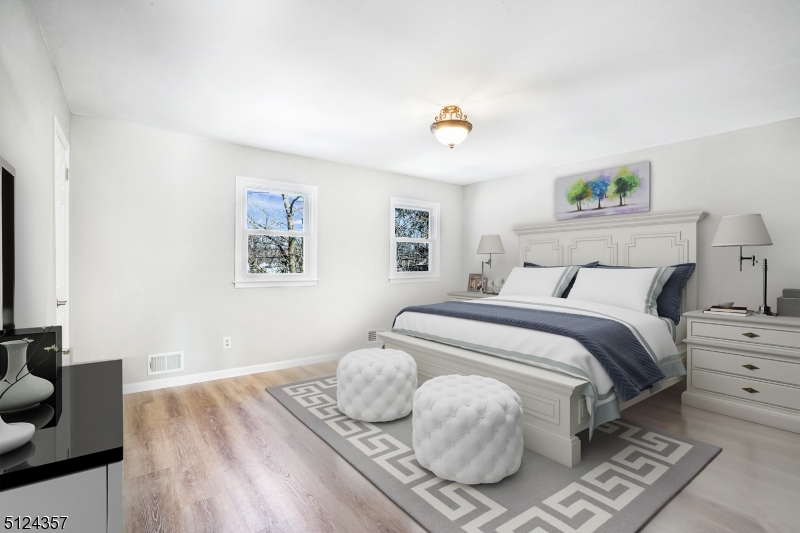 1 Tempe Wick Road, Unit A Mendham, NJ 07945 - Photo 11 of 22 a bedroom with a bed and wooden floor