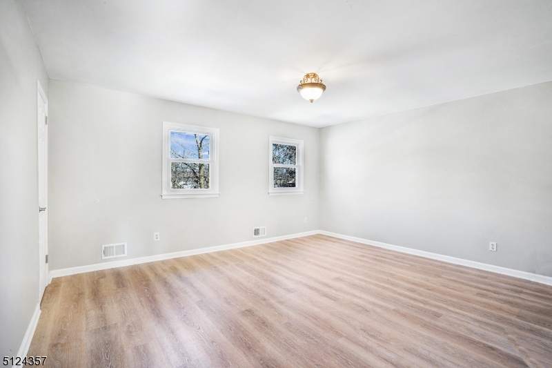 1 Tempe Wick Road, Unit A Mendham, NJ 07945 - Photo 12 of 22 an empty room with wooden floor and windows