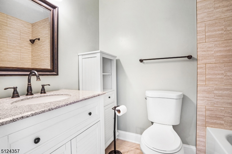 1 Tempe Wick Road, Unit A Mendham, NJ 07945 - Photo 16 of 22 a bathroom with a granite countertop toilet sink and mirror