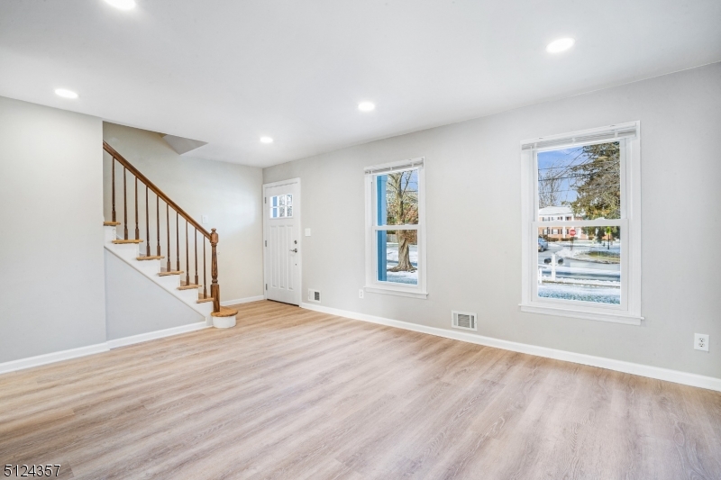 1 Tempe Wick Road, Unit A Mendham, NJ 07945 - Photo 3 of 22 a view of an empty room with wooden floor and a window