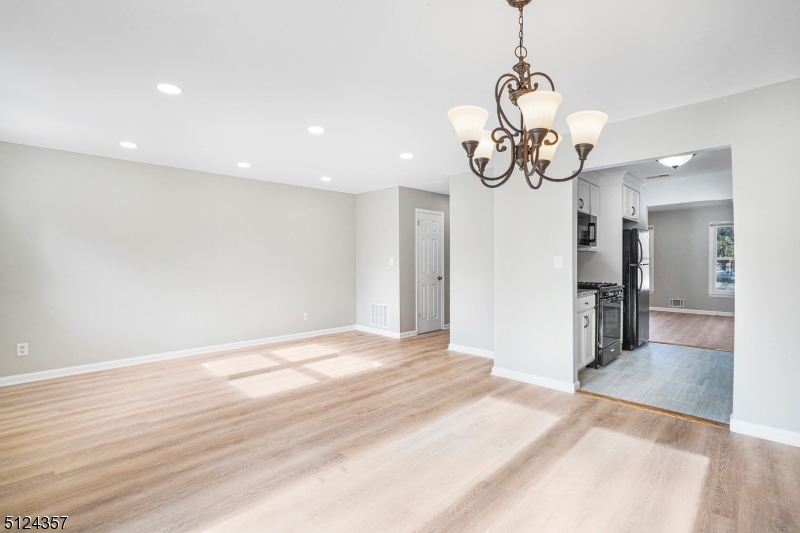 1 Tempe Wick Road, Unit A Mendham, NJ 07945 - Photo 7 of 22 a view of a livingroom with a kitchen chandelier