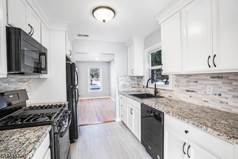 1 Tempe Wick Road, Unit A Mendham, NJ 07945 - Photo 9 of 22 a kitchen with stainless steel appliances granite countertop a sink stove and refrigerator