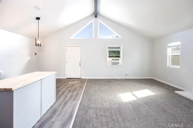 a view of a kitchen with a sink hardwood floor and a window