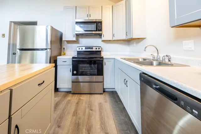 a kitchen with a sink stove and refrigerator