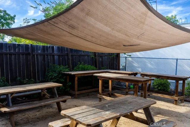 a backyard of a house with barbeque oven table and chairs
