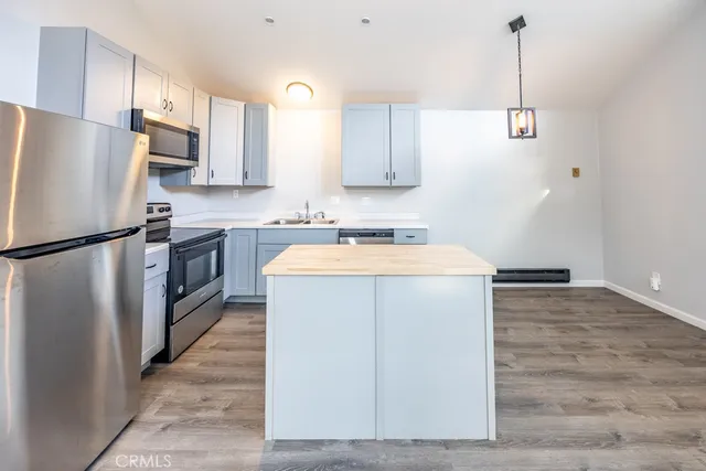 a utility room with cabinets washer and dryer
