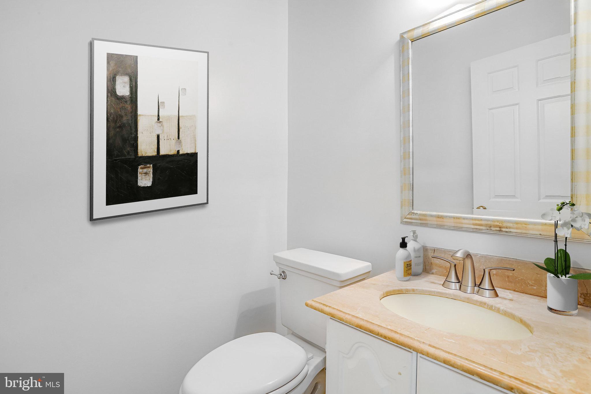 3275 Sutton Place Northwest, Unit A Washington, DC 20016 - Photo 12 of 27 a bathroom with a granite countertop toilet sink and mirror