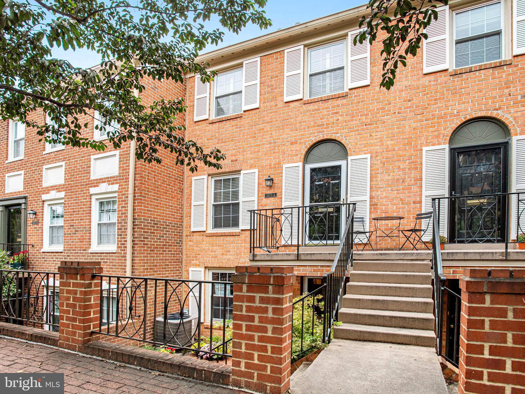 3275 Sutton Place Northwest, Unit A Washington, DC 20016 - Photo 2 of 27 a front view of a house with a porch