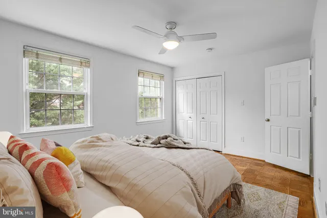 a bed sitting in a bedroom next to a window and a dresser