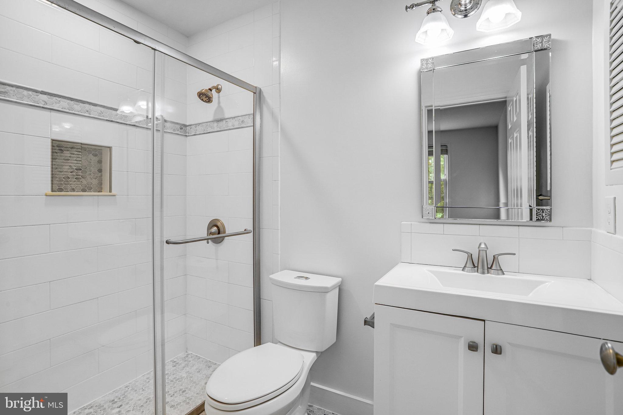 3275 Sutton Place Northwest, Unit A Washington, DC 20016 - Photo 24 of 27 a bathroom with a sink a toilet and shower