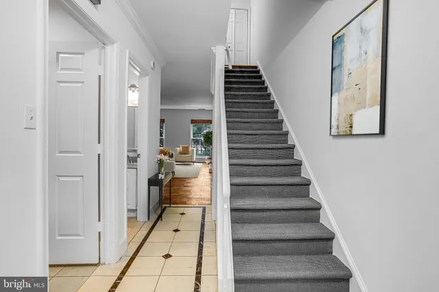 a view of a hallway with a door and stairs
