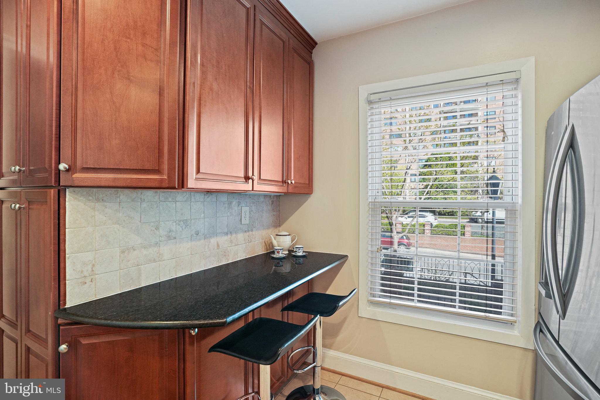 3275 Sutton Place Northwest, Unit A Washington, DC 20016 - Photo 9 of 27 a room with wooden floor and a window
