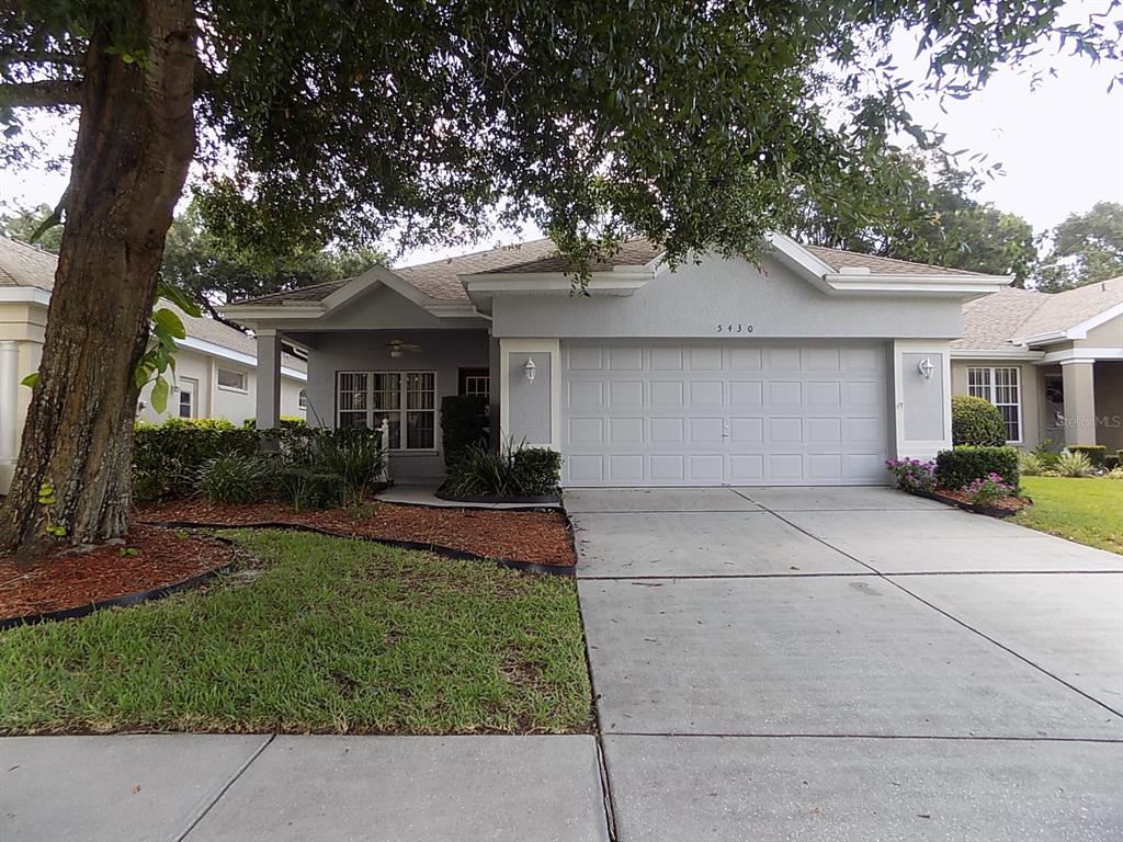 5430 Legend Hills Lane Spring Hill, FL 34609 - Photo 1 of 1 front view of house with a yard