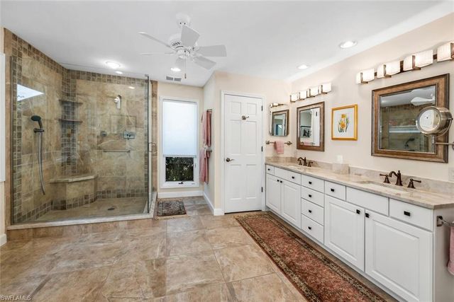 a bedroom with two beds and large window with view of bedroom