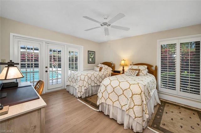 a bathroom with a granite countertop sink toilet and painting on the wall
