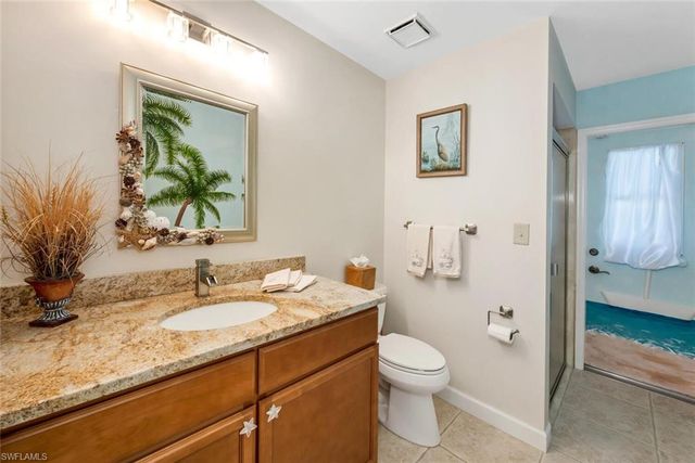 a bedroom with two beds and painting on the wall