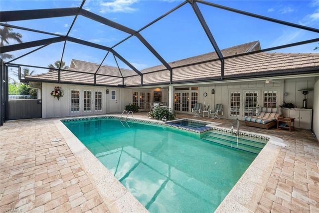 a indoor swimming pool with outdoor seating and yard