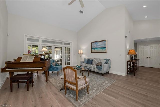 a view of dining room with furniture wooden floor and chandelier