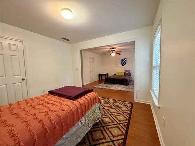 a bedroom with a bed and glass door