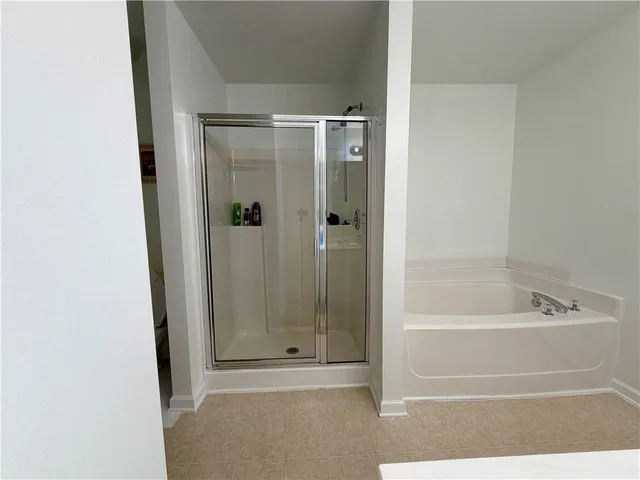 a bathroom with a bathtub and a shower