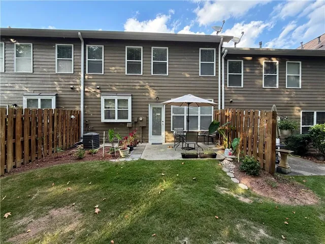 a view of a house with backyard sitting area and garden