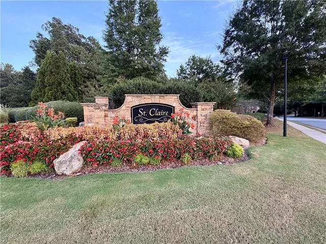 a view of a garden with flowers and trees