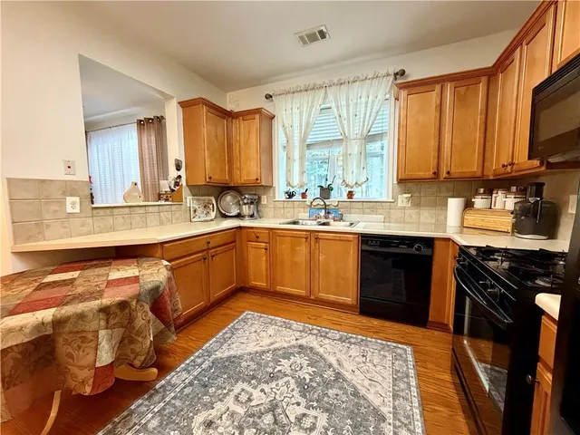 a kitchen with a sink stove and cabinets