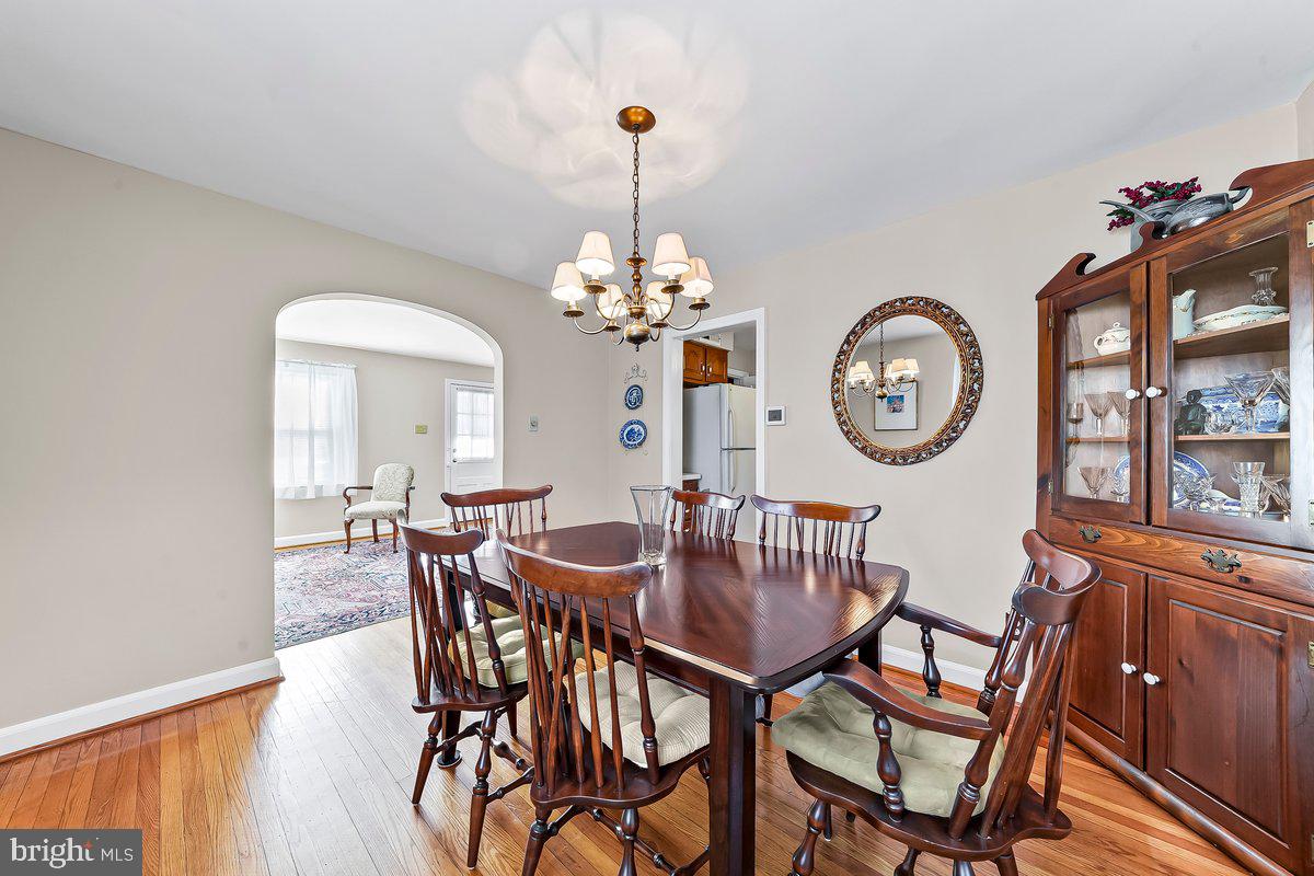 428 Wheatsheaf Road Springfield, PA 19064 - Photo 11 of 40 a dining room with furniture a chandelier and wooden floor