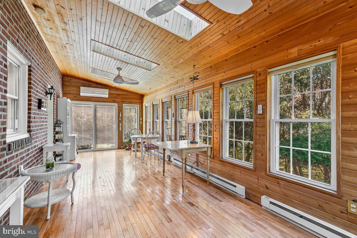428 Wheatsheaf Road Springfield, PA 19064 - Photo 14 of 40 a view of a patio with table and chairs and wooden floor