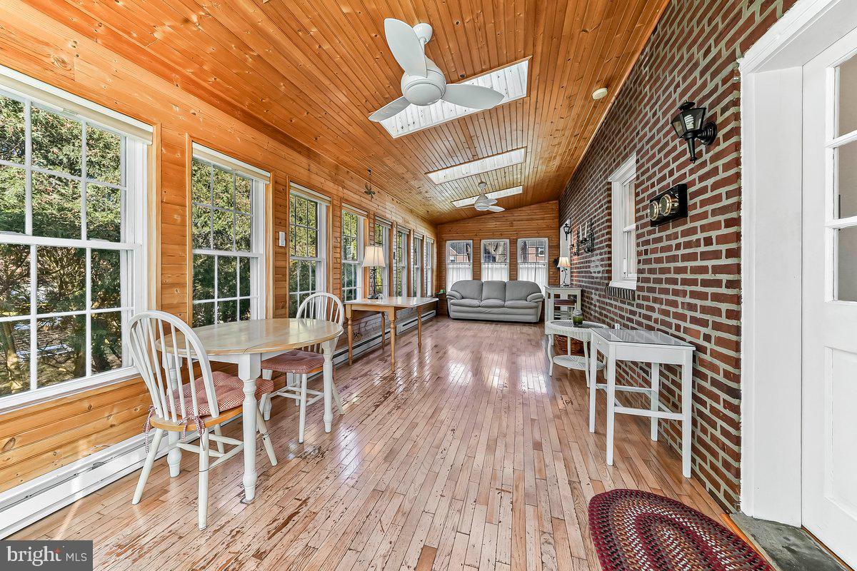 428 Wheatsheaf Road Springfield, PA 19064 - Photo 16 of 40 a view of a dining room with furniture window and wooden floor