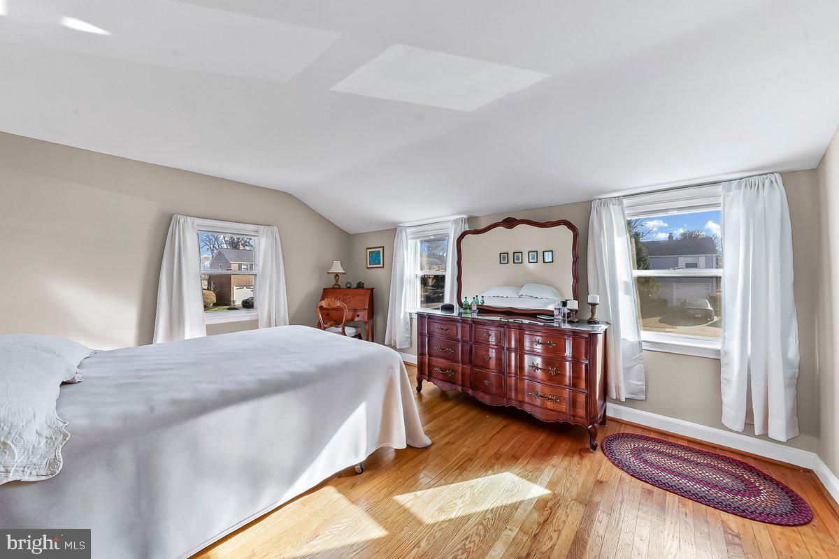 428 Wheatsheaf Road Springfield, PA 19064 - Photo 22 of 40 a bedroom with a bed and wooden floor