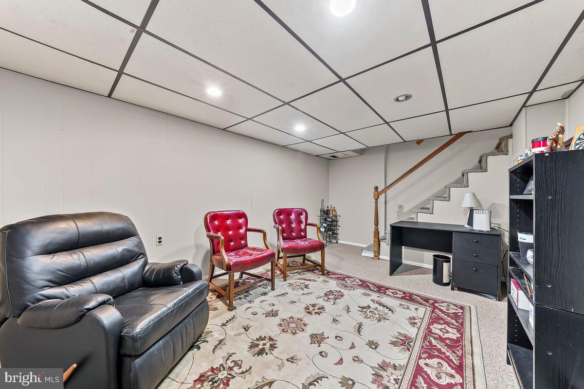 428 Wheatsheaf Road Springfield, PA 19064 - Photo 32 of 40 a living room with furniture and a fireplace