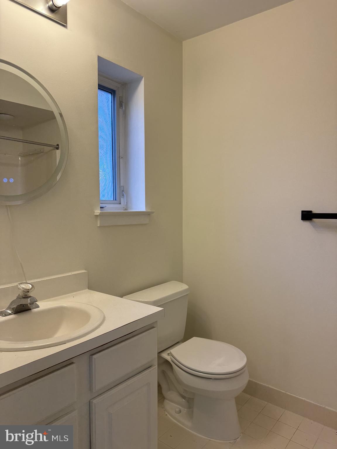 3308 Eastview Lane Wilmington, DE 19802 - Photo 5 of 7 a bathroom with a sink a toilet and mirror