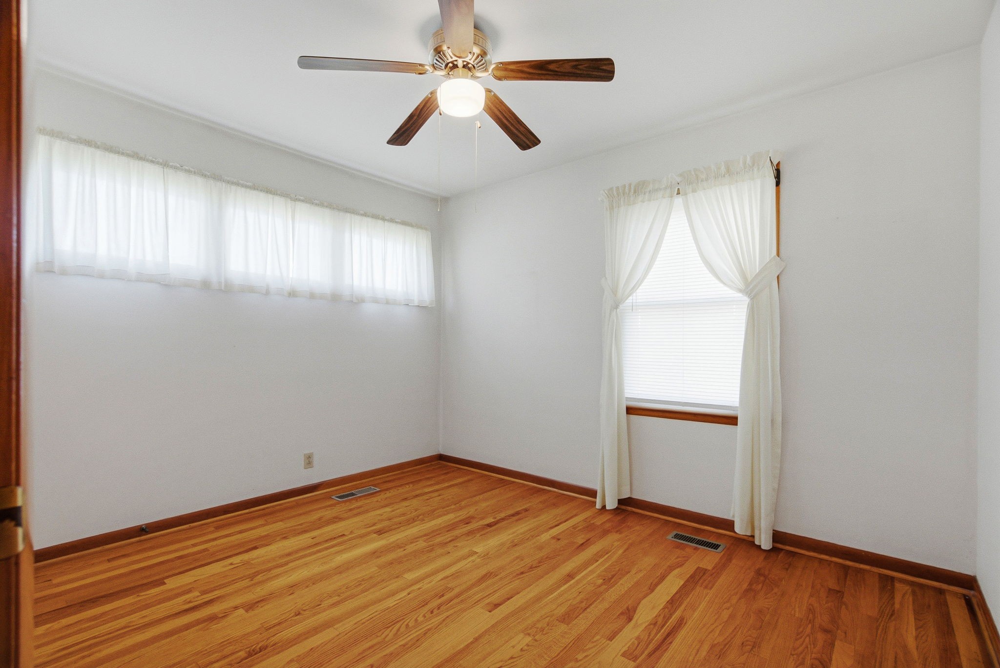 5204 Highway 161 Springfield, TN 37172 - Photo 18 of 40 an empty room with wooden floor chandelier fan and windows