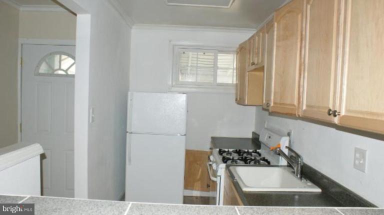 7604 Greenleaf Road Hyattsville, MD 20785 - Photo 2 of 6 a kitchen with a refrigerator and a stove top oven