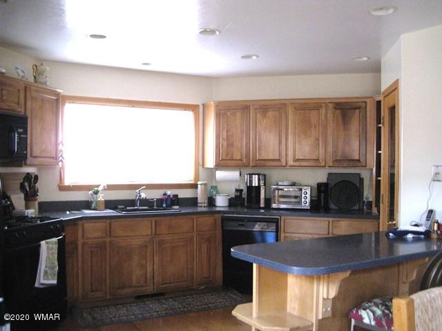 1922 Artist Draw Road Heber, AZ 85928 - Photo 14 of 63 a kitchen with stainless steel appliances granite countertop a sink a stove a counter space and cabinets