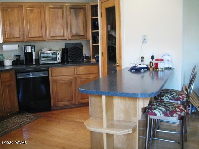 1922 Artist Draw Road Heber, AZ 85928 - Photo 18 of 63 a kitchen with stainless steel appliances granite countertop a stove and white cabinets