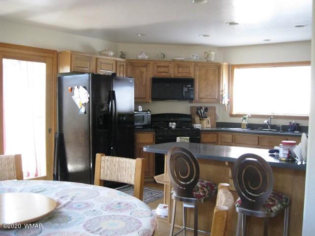 1922 Artist Draw Road Heber, AZ 85928 - Photo 19 of 63 a kitchen with kitchen island a stove a sink and a refrigerator