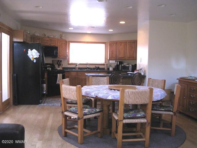1922 Artist Draw Road Heber, AZ 85928 - Photo 21 of 63 a kitchen with a dining table chairs and refrigerator