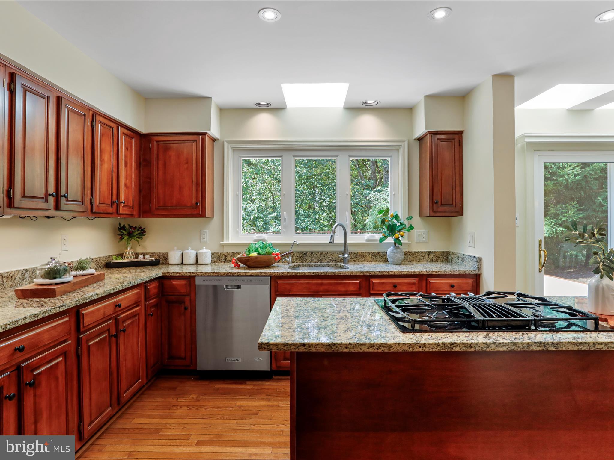 1350 Hunter Mill Road Reston, VA 20190 - Photo 12 of 75 a kitchen with stainless steel appliances granite countertop a stove a sink dishwasher and a microwave oven on the blue kitchen countertops