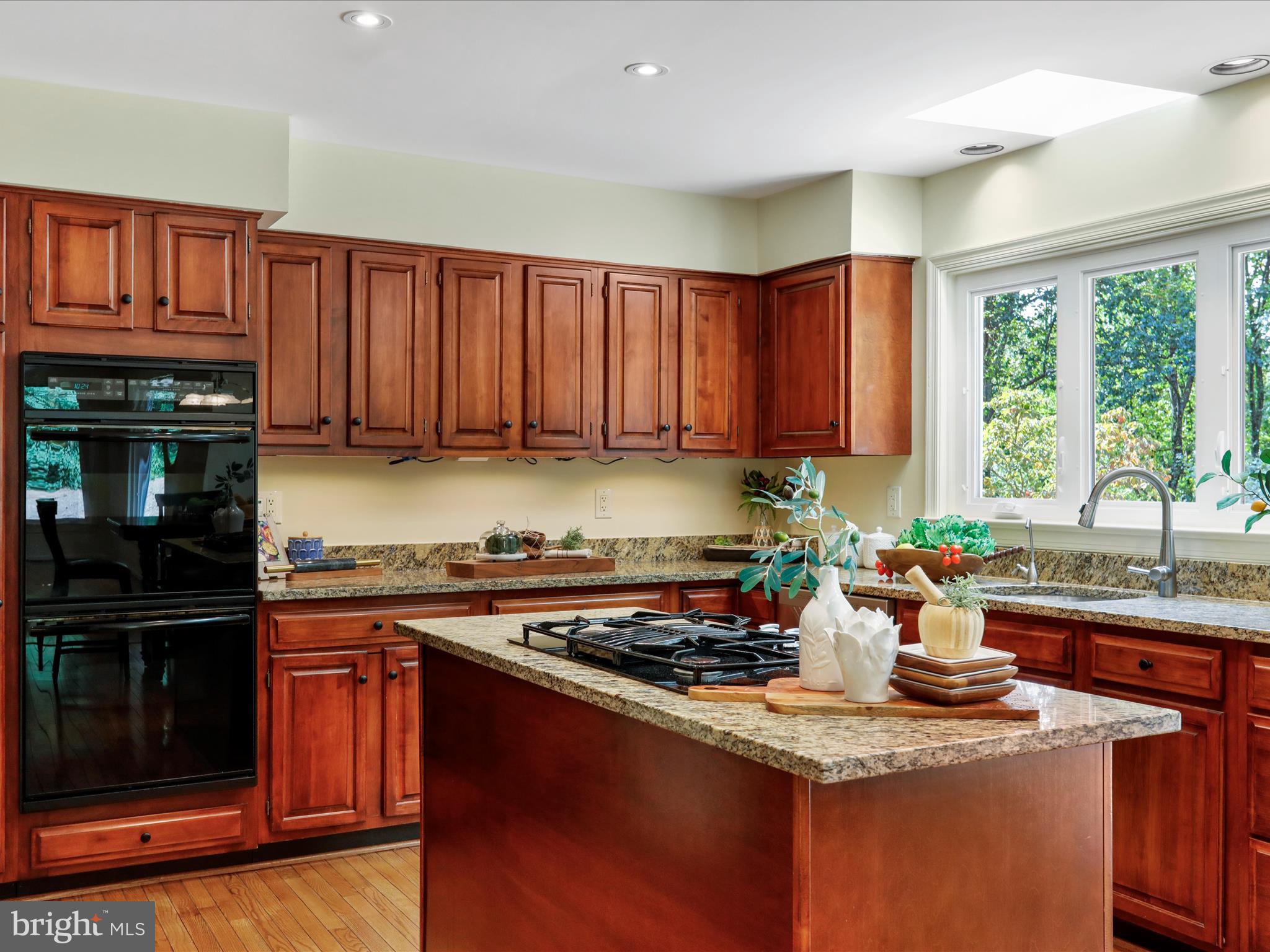 1350 Hunter Mill Road Reston, VA 20190 - Photo 17 of 75 a kitchen with stainless steel appliances granite countertop a stove a sink dishwasher and a microwave oven with cabinets