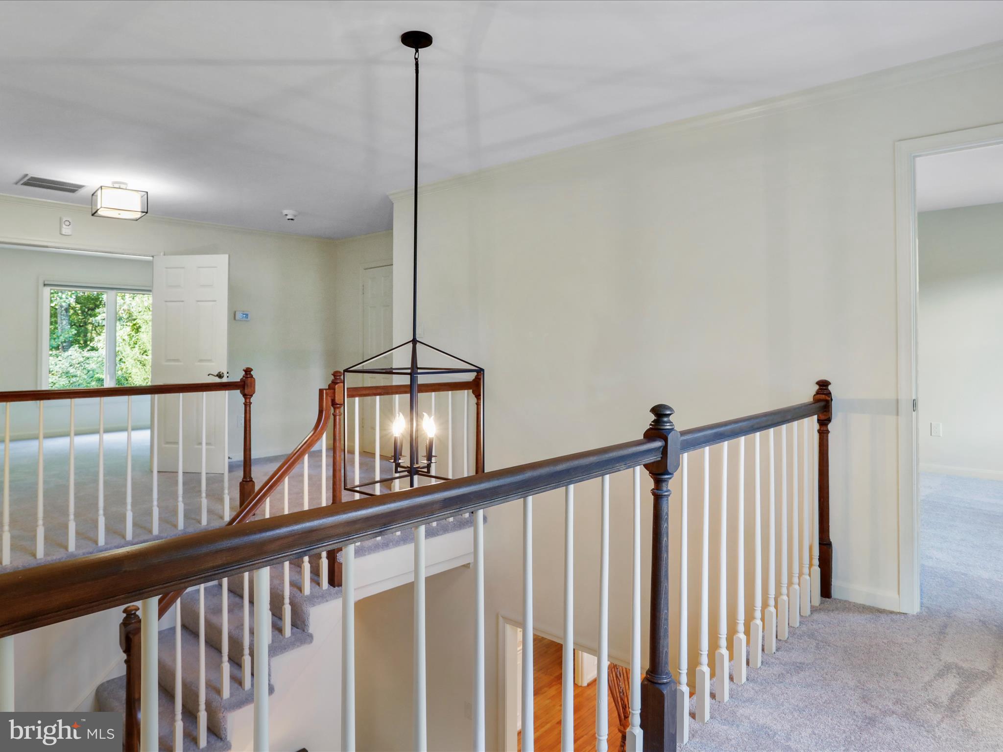 1350 Hunter Mill Road Reston, VA 20190 - Photo 39 of 75 a view of staircase with railing and a chandelier