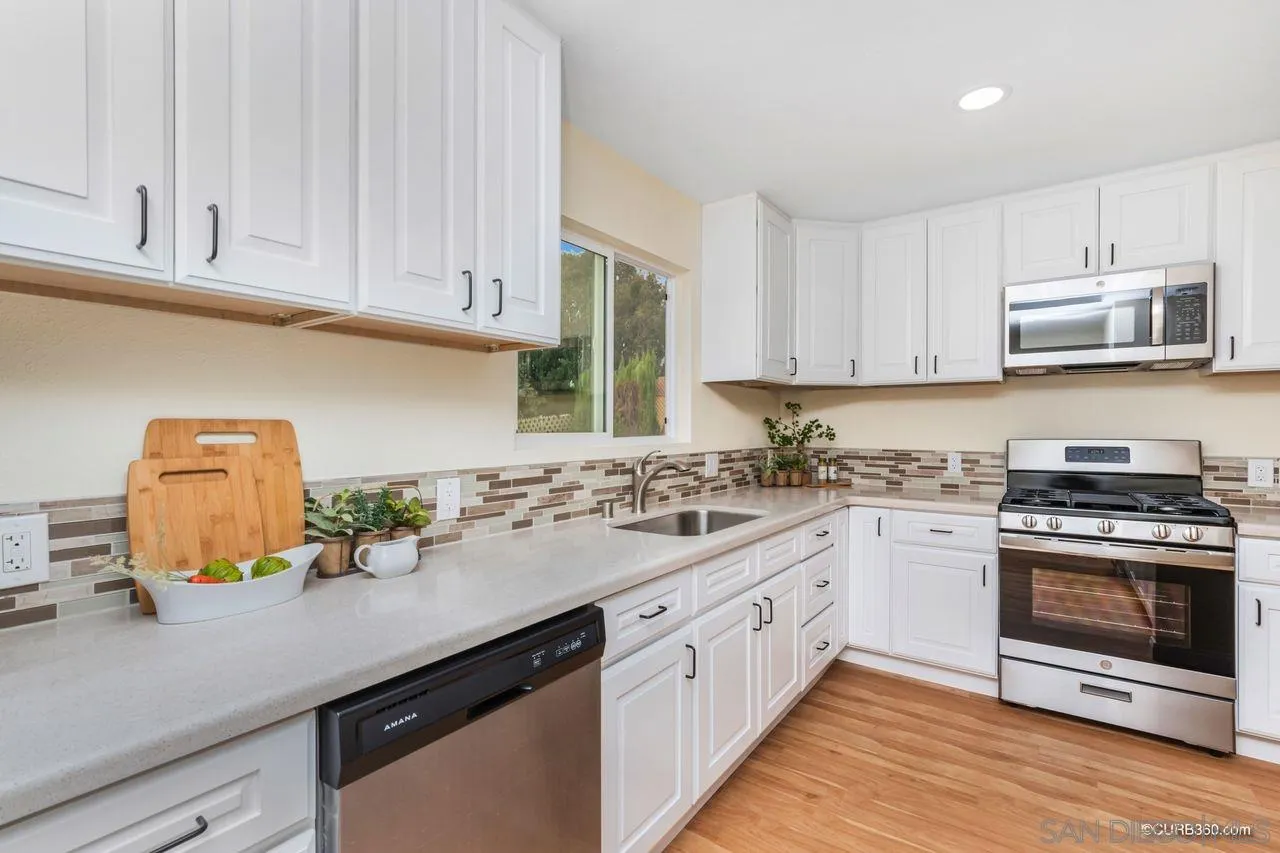 1427 Panorama Ridge Road Oceanside, CA 92056 - Photo 13 of 33 a kitchen with appliances cabinets and a counter top space