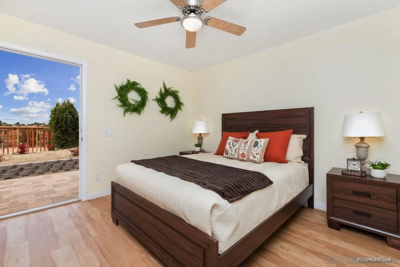 1427 Panorama Ridge Road Oceanside, CA 92056 - Photo 15 of 33 a bedroom with a bed and a chandelier