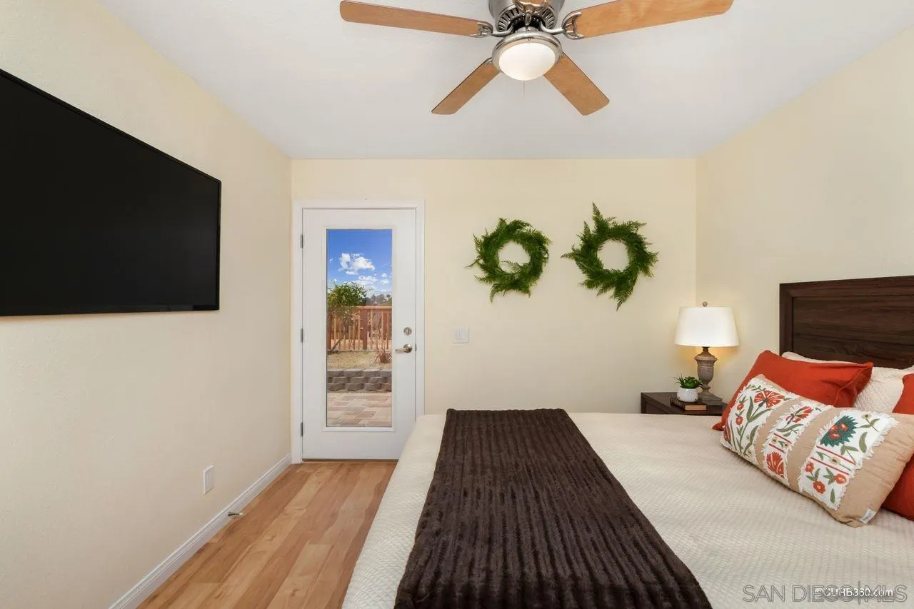 1427 Panorama Ridge Road Oceanside, CA 92056 - Photo 16 of 33 a bedroom with a bed and a flat screen tv