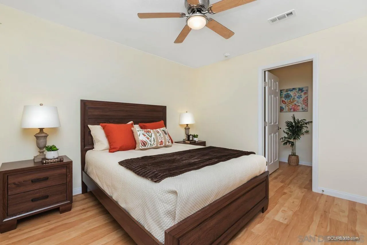 1427 Panorama Ridge Road Oceanside, CA 92056 - Photo 17 of 33 a bedroom with bed and a chandelier